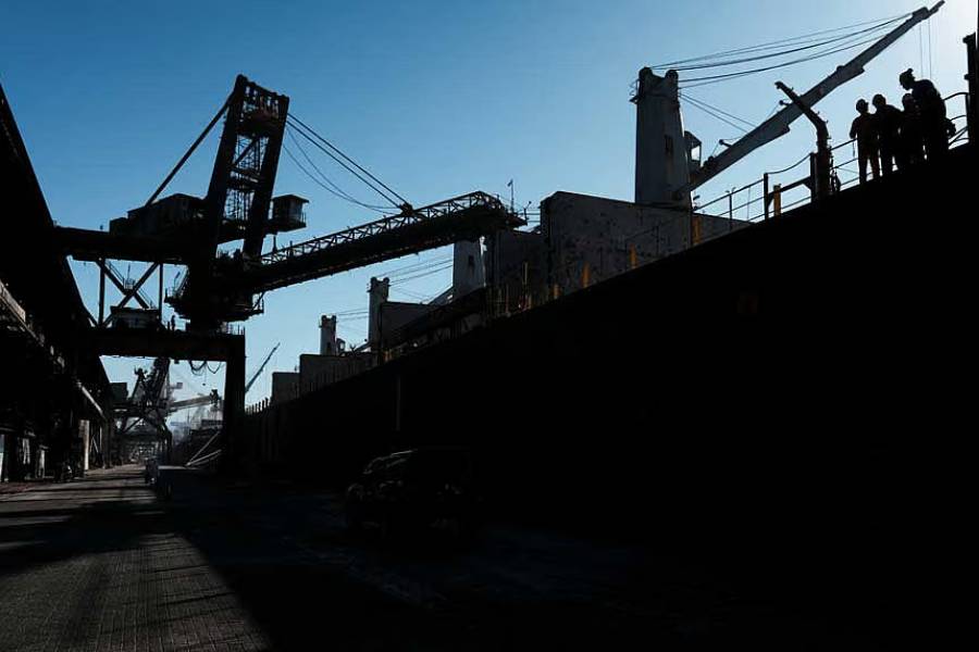 Workers are silhouetted in a cargo ship heading to Nigeria as it is loaded with sugar at Brazil’s main ocean port, Santos, Brazil, May 13, 2026.