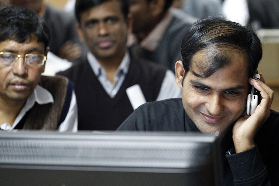 Investors react while monitoring stock price movements on a computer screen at a brokerage house in the capital. — FE/File