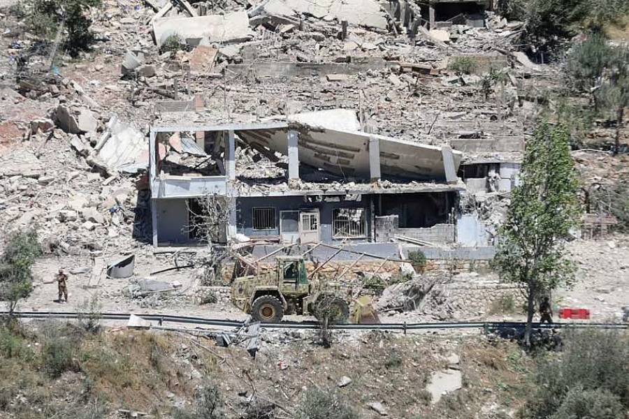 Machinery operates, as the Lebanese army opens a road, past buildings destroyed during the Israeli military campaign, in Dibbin, southern Lebanon Jun 4, 2026.