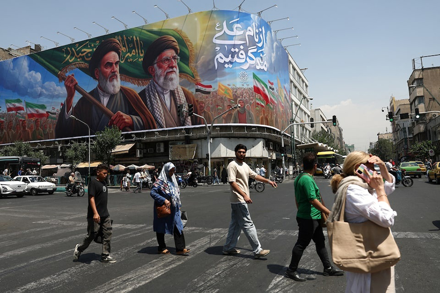 People walk past a billboard depicting the late leader of the Islamic Revolution, Ayatollah Ruhollah Khomeini, and the late Iran's Supreme Leader Ayatollah Ali Khamenei, on a street in Tehran, Iran on June 6, 2026 — WANA (West Asia News Agency) via REUTERS