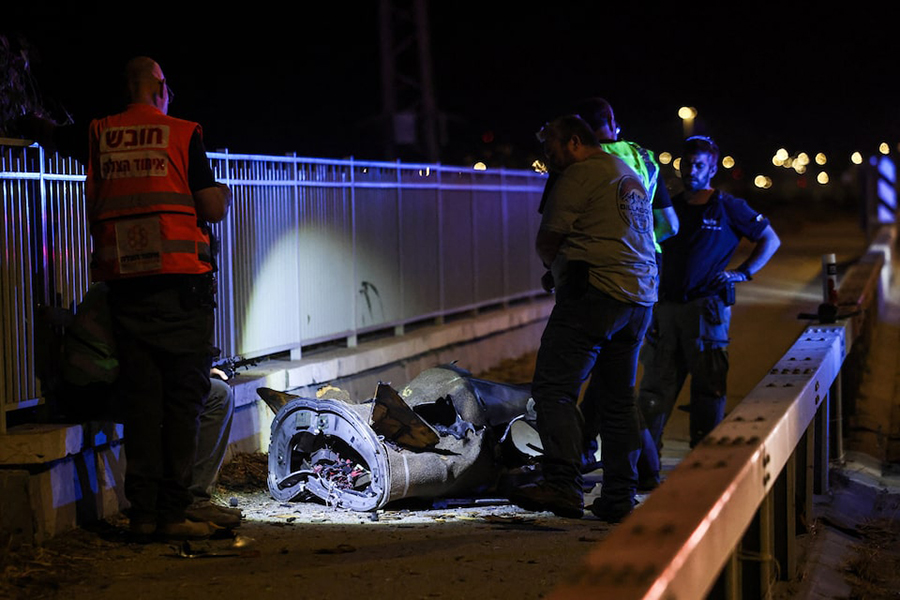 Israeli security and rescue personnel work next to a part of a projectile following a missile attack from Iran towards Israel in northern Israel, on June 8, 2026 — Reuters photo