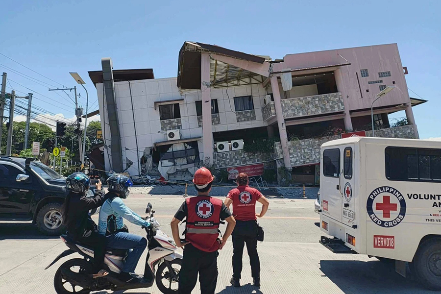 In this photo provided by the Philippine Red Cross, rescuers inspect the damage after an earthquake in General Santos, Philippines, on Monday, June 8, 2026 — Philippine Red Cross via AP