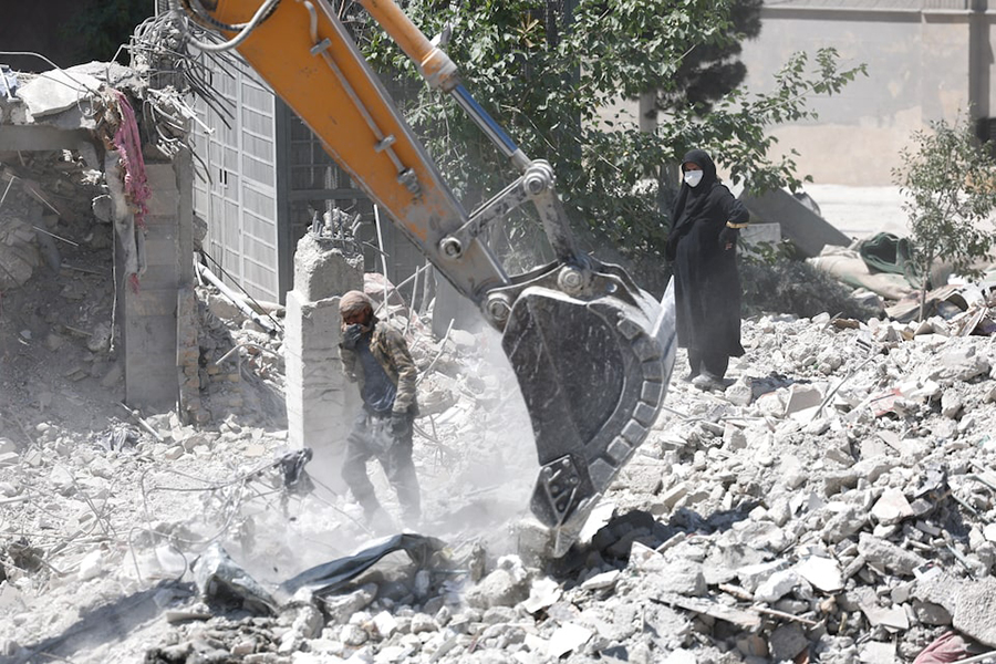 A woman stands among the rubble of her house, which was damaged in a US and Israeli strike in March, in Tehran, Iran on June 7, 2026. — WANA (West Asia News Agency) via REUTERS