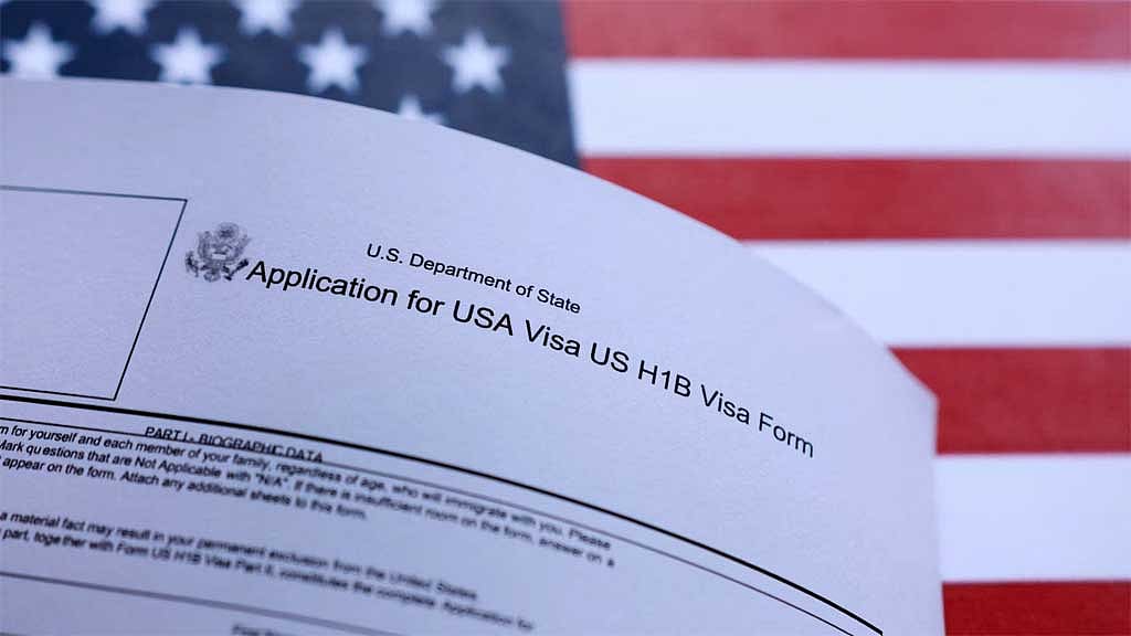 A US flag and a US H-1B Visa application form are seen in this illustration taken, September 22, 2025. Reuters