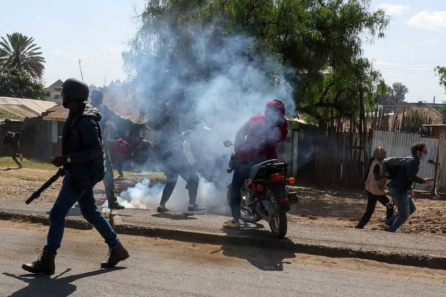 Demonstrators run from tear gas dispersed by police, as they take part in a protest against a US-backed Ebola quarantine plan to establish a 50-bed facility at a Kenyan air force base intended to host Americans exposed to Ebola, in Nanyuki town, Laikipia County, Kenya, Jun 9, 2026.