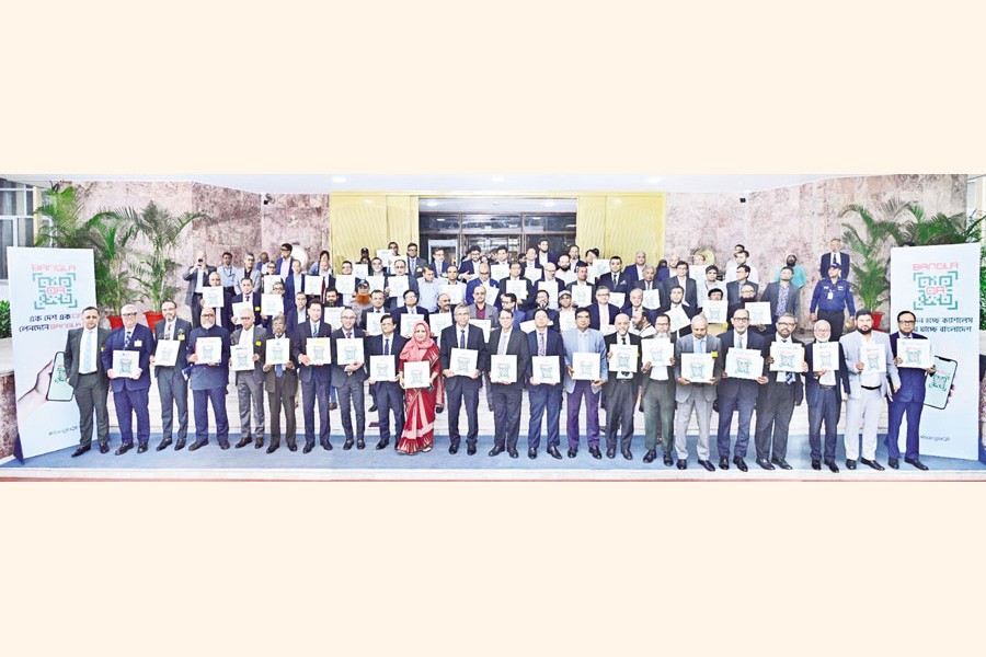 Senior executives of commercial banks, mobile financial service (MFS) providers, payment service providers (PSPs) and payment system operators (PSOs) pose for a photograph after launching a nationwide campaign to promote "Bangla QR" at the Bangladesh Bank headquarters in the capital on Wednesday. The interoperable digital payment platform is scheduled to roll out nationwide from July. — FE photo