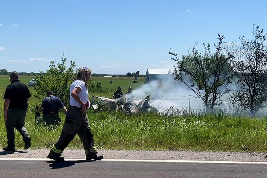 Firefighters work on the site of an aircraft crash in Butler, Missouri, US, on June 14, 2026, in this still image taken from a video. Mid America Live News/Handout via REUTERS