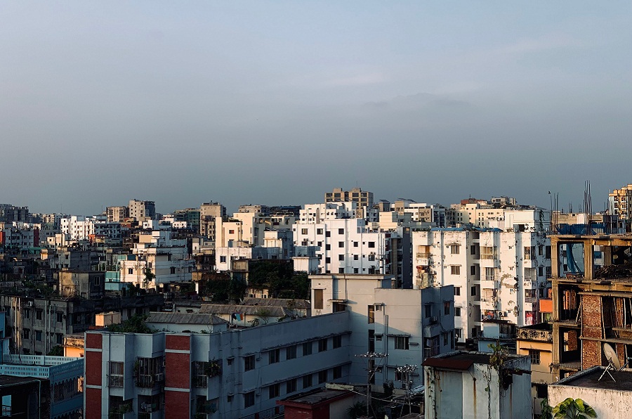 Aerial view showcasing the densely packed residential architecture of Dhaka under a clear sky.