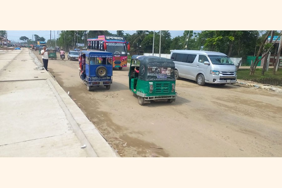 People suffer acute due to traffic congestion in the four-lane part of the Sylhet-Sunamganj highway especially amid rain as electric poles in the midst are not being removed by the PDB -FE Photo