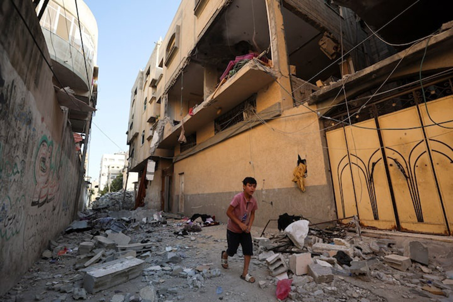 A Palestinian boy runs past the site of an Israeli strike on an apartment in Gaza City, on June 20, 2026. — Reuters photo