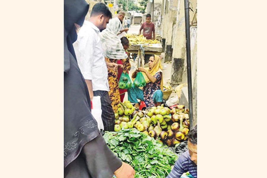 Photo shows a woman busy selling kernels of raw palm at Baitul Amin Chattar in Chandpur town - FE Photo