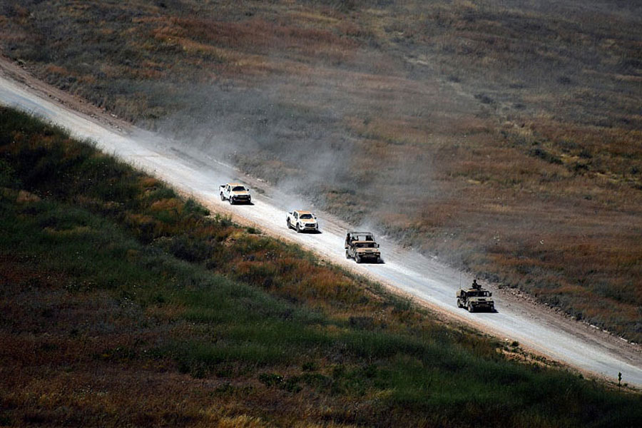 Israeli military vehicles drive on a Lebanese road by the Israel-Lebanon border, as seen from northern Israel, Jun 18, 2026.
