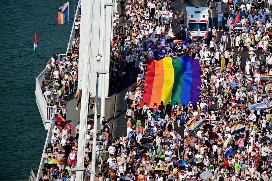People cross Elizabeth Bridge with a rainbow flag as they attend the Budapest Pride March in Budapest, Hungary, June 27, 2026.