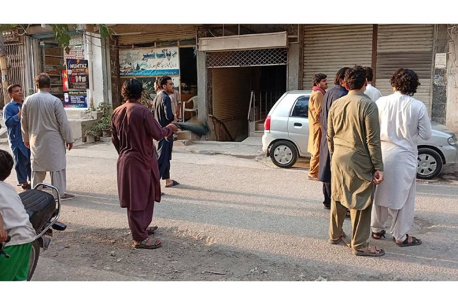 People stand in the street following an earthquake in Peshawar, Pakistan Jun 27, 2026. Picture taken with a mobile phone.