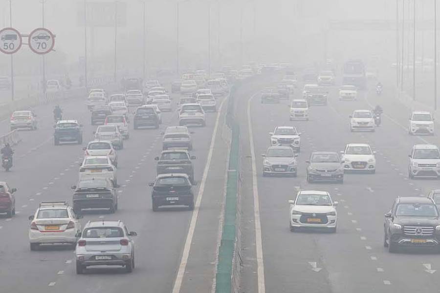 Traffic moves along a highway amidst air pollution in New Delhi, India, Dec18, 2025.