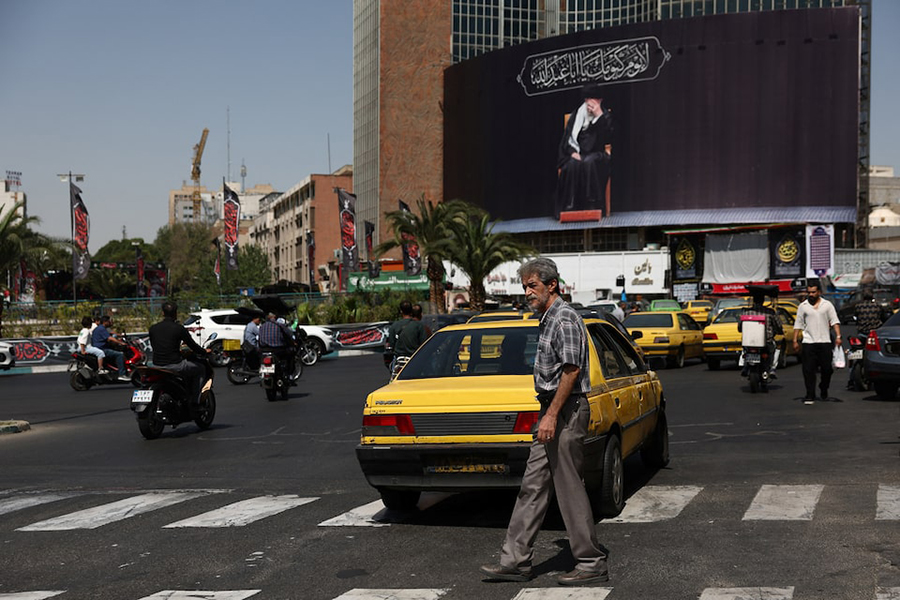 People move past a billboard with an image of Iran's late Supreme Leader Ayatollah Ali Khamenei in Tehran, Iran, on June 30, 2026. — WANA (West Asia News Agency) via REUTERS