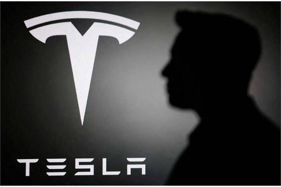 The silhouette of Elon Musk and Tesla logo are seen in this illustration taken Jun 11, 2026.
