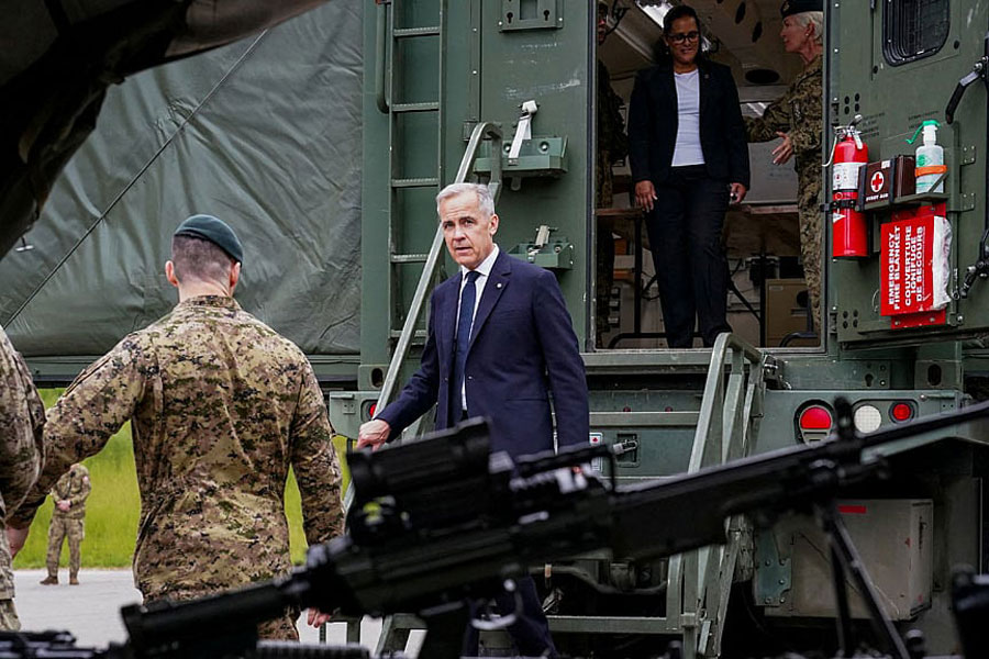 Canada’s Prime Minister Mark Carney walks out of a military truck at Fort York Armoury, in Toronto, Ontario, Canada Jun 9, 2025. REUTERS/Arlyn McAdorey/File Photo