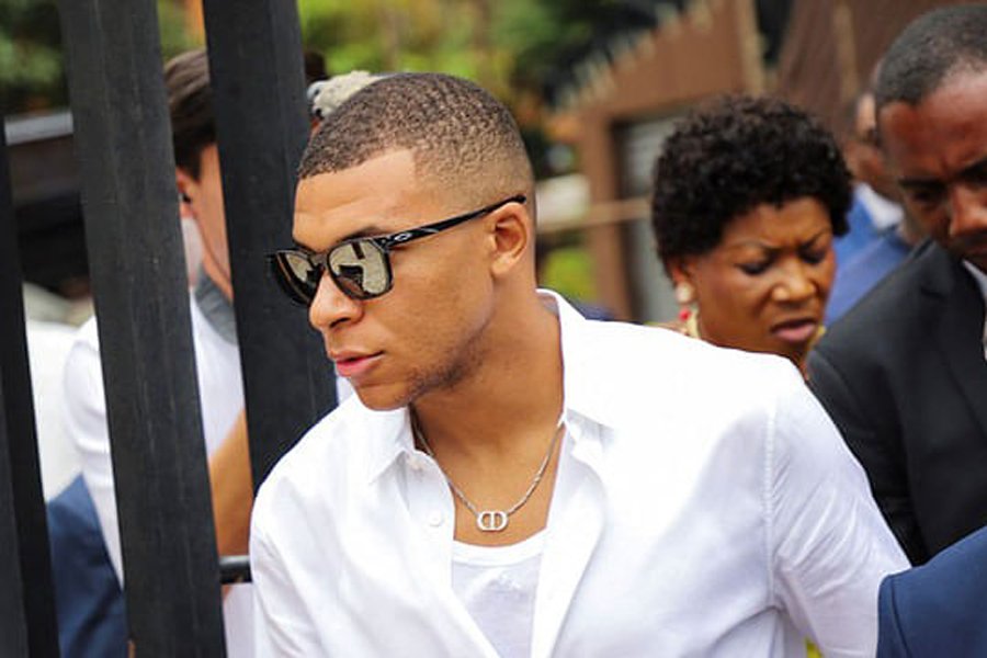 French international football star Kylian Mbappe walks as he continues his first visit to his father's homeland in Yaounde, Cameroon Jul 7, 2023.