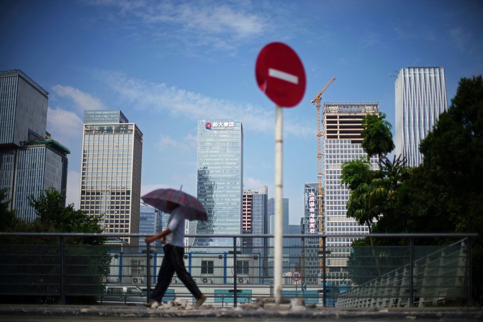 A man walks past a No Entry traffic sign near the headquarters of China Evergrande Group in Shenzhen, Guangdong province, China on September 26, 2021 — Reuters/Files