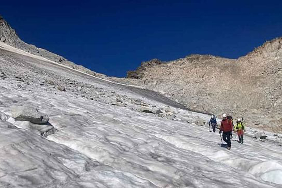 Researchers from Pyrenean Institute of Ecology walk at El Aneto glacier, as extreme heat is accelerating the melting disappearance of the largest glacier in the Pyrenees, in Benasque, Spain, Aug 8, 2023.