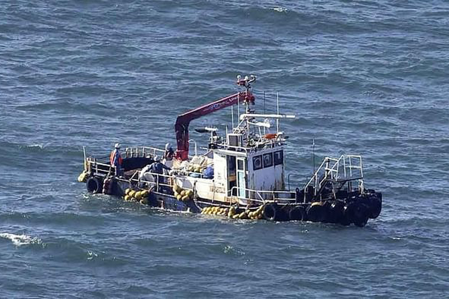 A boat collecting seawater for monitoring radioactive materials in the sea is seen near the Fukushima Daiichi Nuclear Power Plant, after the nuclear power plant started releasing treated radioactive water into the Pacific Ocean, in Okuma, Fukushima prefecture, Japan Aug 24, 2023, in this photo taken by Kyodo.
