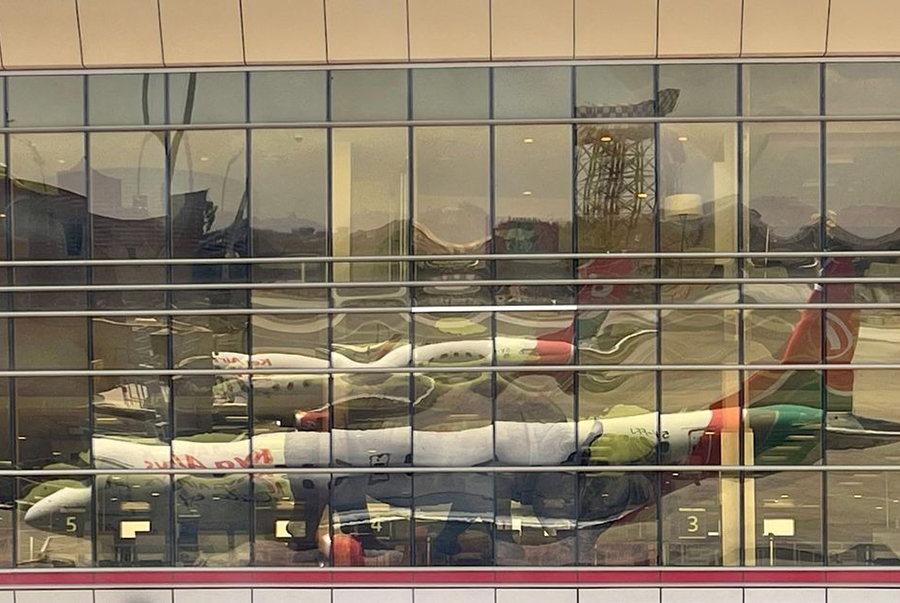 A reflection from the windows show Kenya Airways planes parked at terminal within the Jomo Kenyatta International Airport near Nairobi, Kenya on March 7, 2023 — Reuters/Files