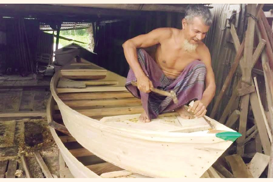 An old boat maker busy making boats at Chhotaki village in Matlab Uttar upazila in Chandpur district — FE Photo
