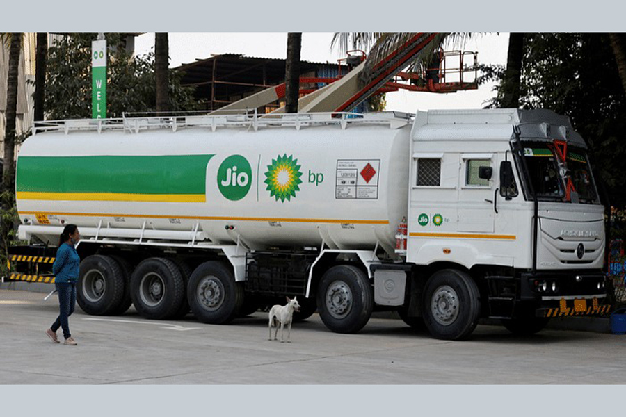 A woman walks past a Jio-bp fuel tanker, an Indian fuel and mobility joint venture between Reliance Industries (RIL) and British Petroleum (BP), fuel station, in Navi Mumbai, India, Oct 26, 2021.