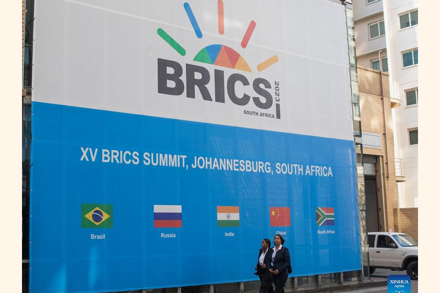 People walk near the venue of the 15th BRICS Summit in Johannesburg, South Africa on August 21, 2023.