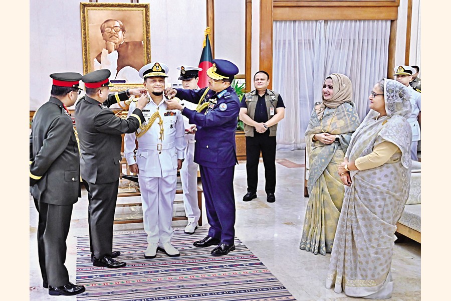 Chief of Naval Staff M Nazmul Hassan is being adorned with the new rank badge in presence of Prime Minister Sheikh Hasina at her official residence Ganabhaban in the city on Sunday — PID