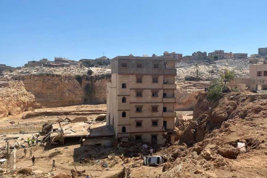People walking amidst the wreckage, in the aftermath of the floods in Libyan city of Derna on Friday –Reuters photo
