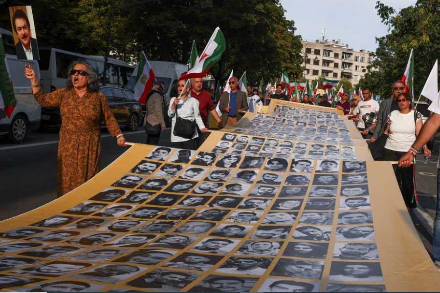 People holding a placard with pictures of, as Iranian call them, martyrs, during a rally of Iranian diaspora in Europe, on the eve of the first anniversary of the death of Mahsa Amini, which prompted protests across their country, in Brussels of Belgium on Friday –Reuters photo
