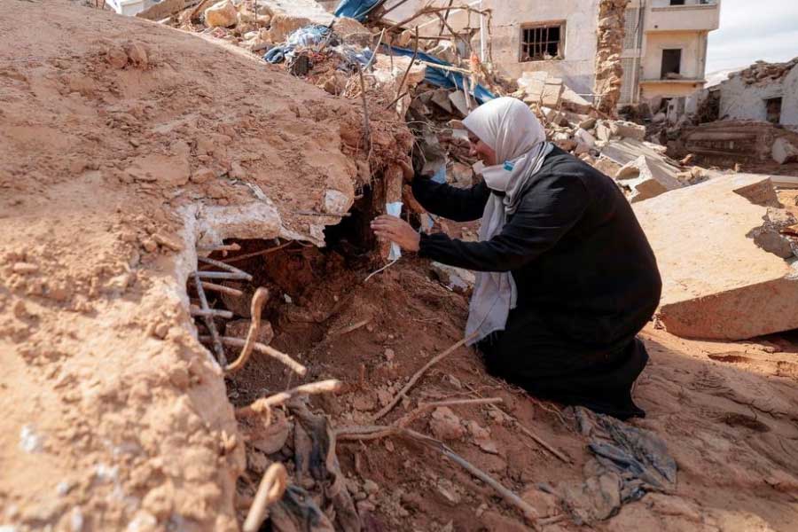 Sabrine Ferhat Bellil, who said she lost her brother, his wife and 5 of his children when the deadly storm hit her city, reacting amid rubble beside her brother's destroyed house in Derna of Libya on Sunday –Reuters photo