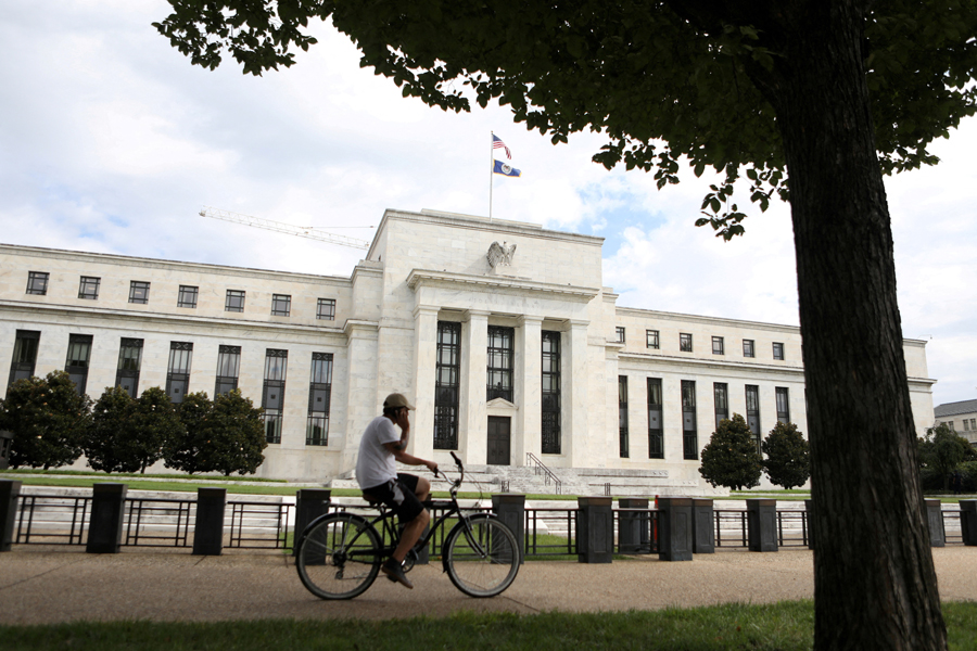 A cyclist passes the Federal Reserve building in Washington, DC, US, August 22, 2018. Reuters/Chris Wattie/File Photo Acquire Licensing Rights