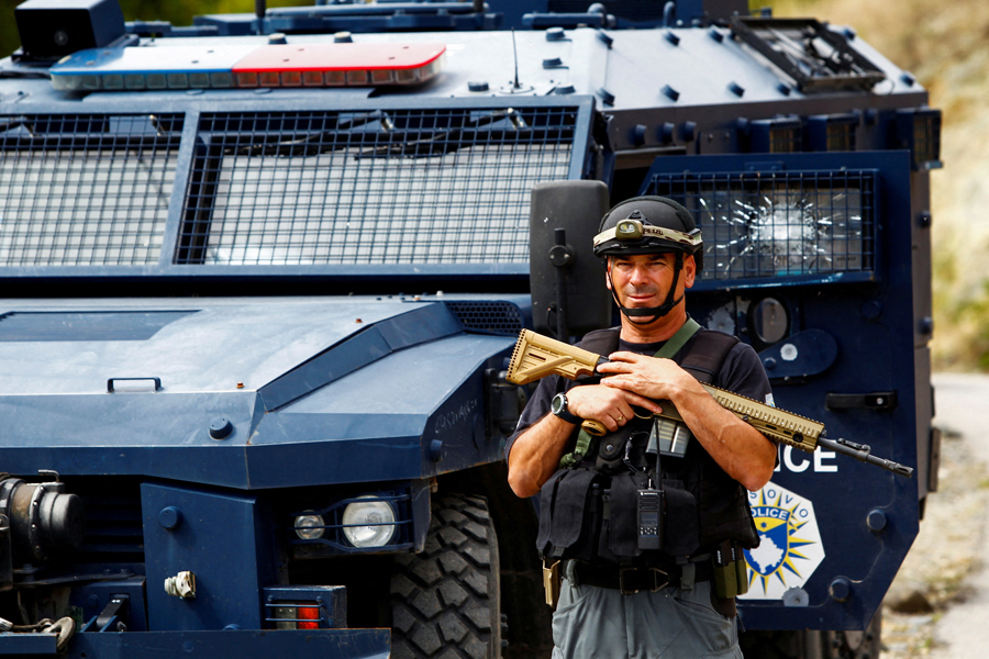 A Kosovo police officer looks on, in the aftermath of a shooting incident, in Banjska village, Kosovo September 27, 2023.