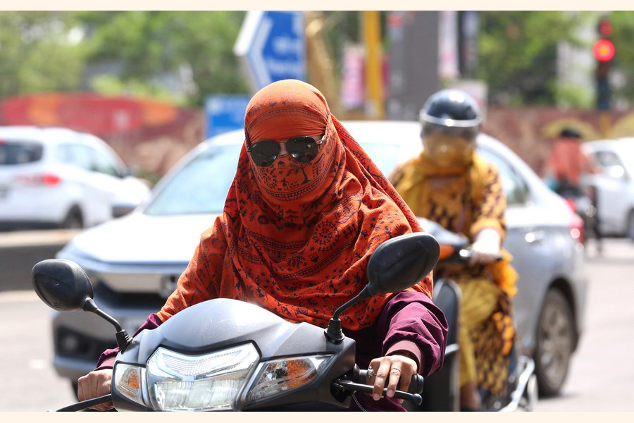 A woman rides with her head covered from the sun during hot summer in Bhopal, capital of India's Madhya Pradesh state, July 6, 2023 — Xinhua Photo