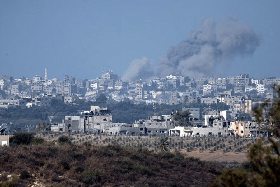 A view shows smoke in the sky and destroyed buildings in the Gaza Strip as seen from Israel's border with the Gaza Strip, in southern Israel Oct 15, 2023.