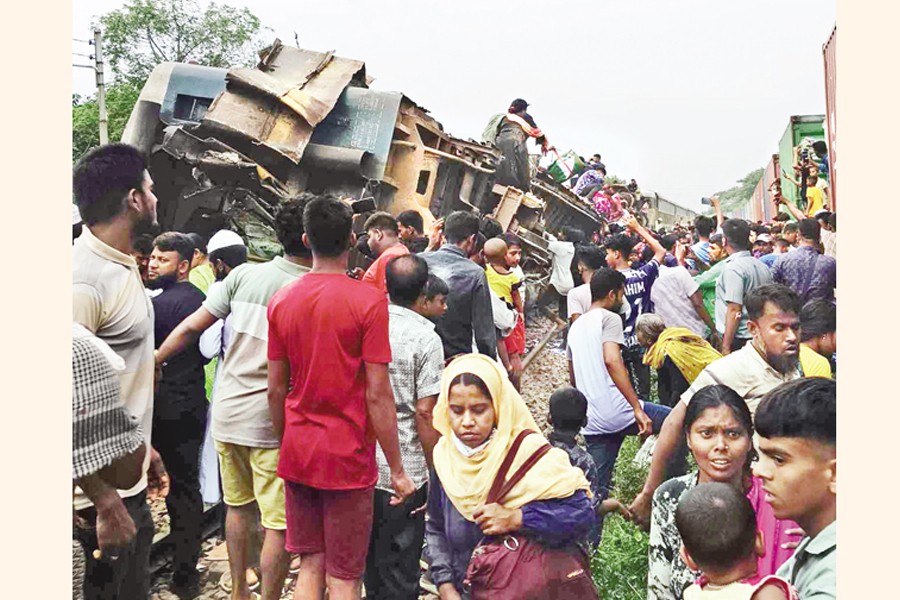 People gather around the wreckage of train compartments following a collision between two trains in Bhairab, Kishoreganj, on Monday. —Focus Bangla photo