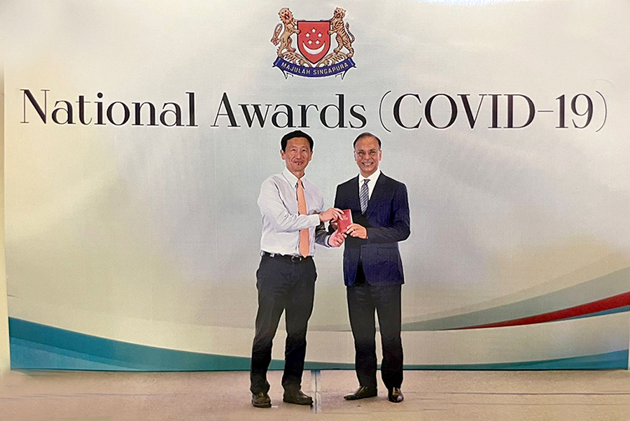 Muhammed Aziz Khan (right) receives the Public Service Medal (COVID-19) from Singapore’s Minister for Health Mr Ong Ye Kung at the National Awards in Singapore Expo