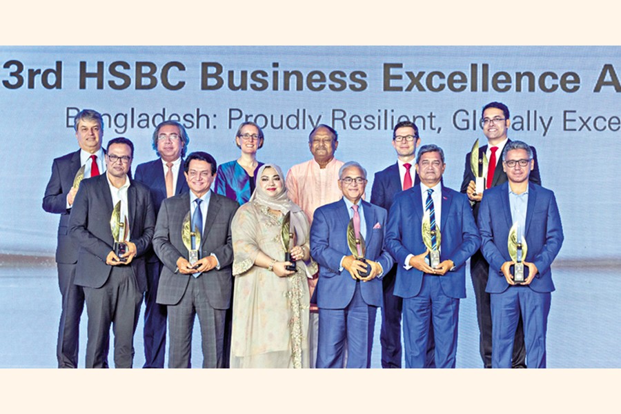 Winners pose with the awards at the 'Third HSBC Business Excellence Awards' ceremony held in Dhaka on Saturday.