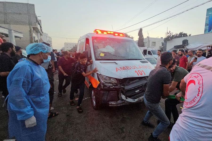 Palestinians pulling an ambulance at the entrance of Shifa hospital in Gaza City on Friday after a convoy of ambulances was hit by an Israeli air strike –Reuters photo