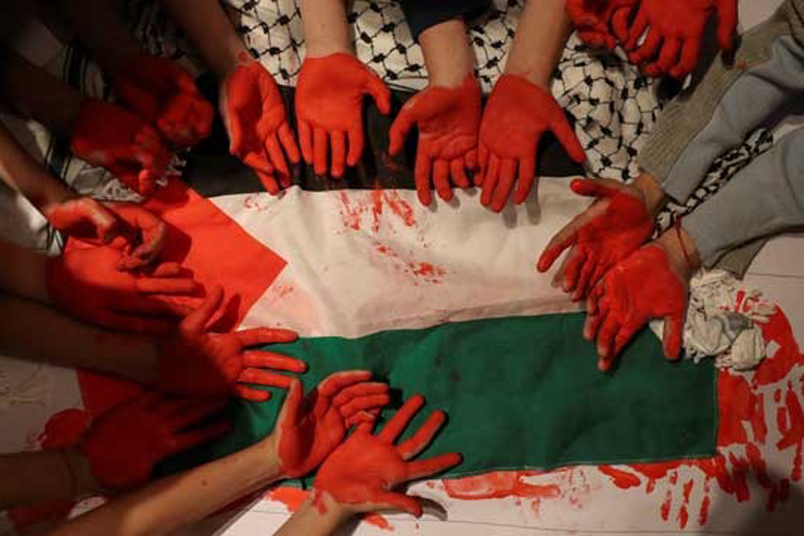 Children show their hands painted in red as members of the Palestinian community living in Chile attend a gathering, in Santiago, Chile, Oct 9, 2023.