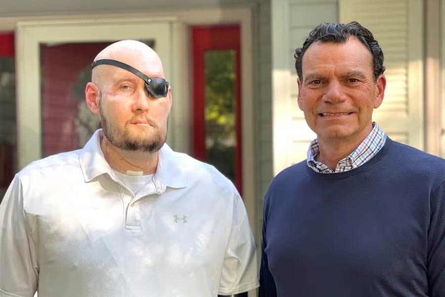 Aaron James of Hot Springs, Arkansas, poses with Dr. Eduardo D. Rodriguez after he underwent surgery for the world’s first whole-eye transplant as part of a partial face transplant at NYU Langone in an undated photograph.