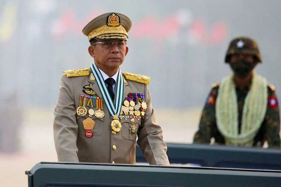 Demonstrators are seen behind barricades during a protest against the military coup in Mandalay, Myanmar Mar 22, 2021.