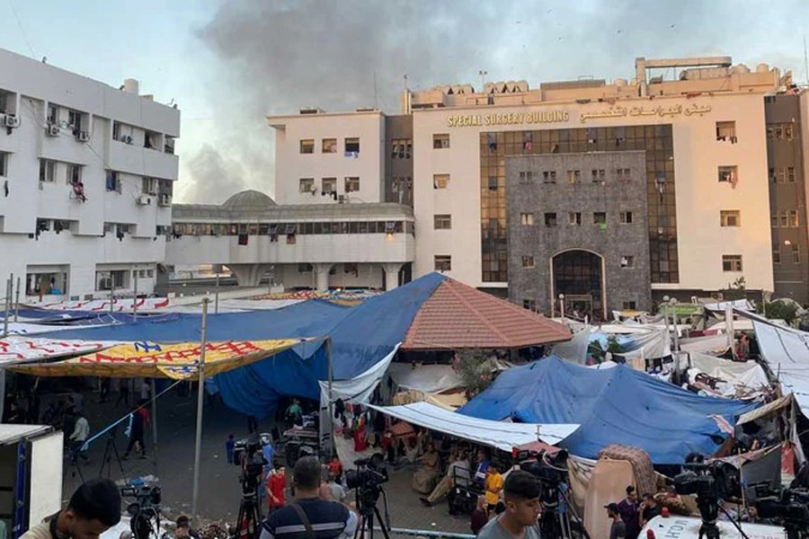 Smoke rises as displaced Palestinians take shelter at Al Shifa hospital, amid the ongoing conflict between Hamas and Israel, in Gaza City, Nov 8, 2023.