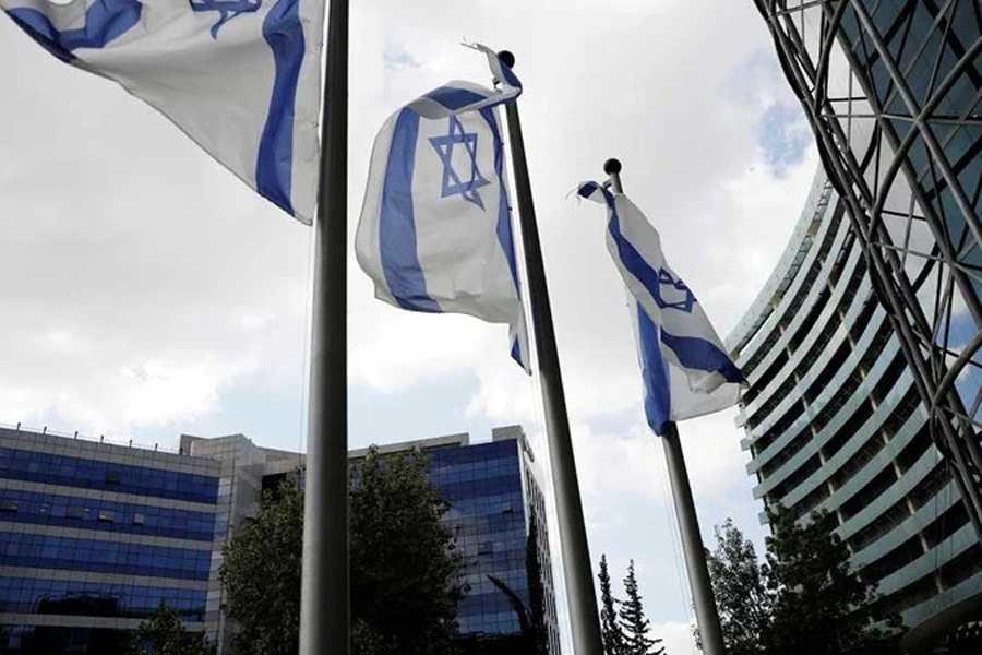 Israeli national flags flutter near office towers at a business park also housing high tech companies, at Ofer Park in Petah Tikva, Israel Aug 27, 2020.