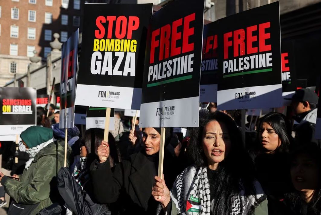Demonstrators hold placards on the day of the protest in solidarity with Palestinians in Gaza, amid the ongoing conflict between Israel and the Palestinian Islamist group Hamas, in London, Britain, November 11, 2023. REUTERS/Hollie Adams