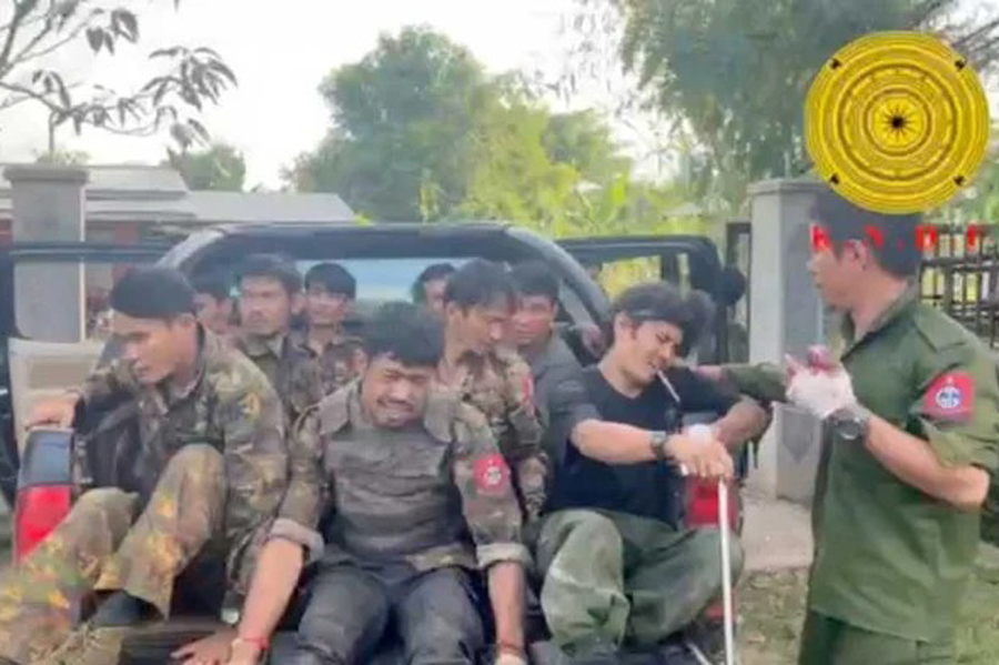 Myanmar military soldiers who have surrendered to the Karenni Nationalities Defense Force ride in the back of a vehicle in Loikaw, Myanmar, in this still image taken from video released Nov 15, 2023.