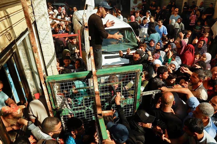 Palestinians waiting to buy bread from a bakery in Khan Younis in the southern Gaza Strip on Friday amid shortages of food supplies and fuel amid the conflict between Israel and Palestinian Islamist group Hamas –Reuters photo
